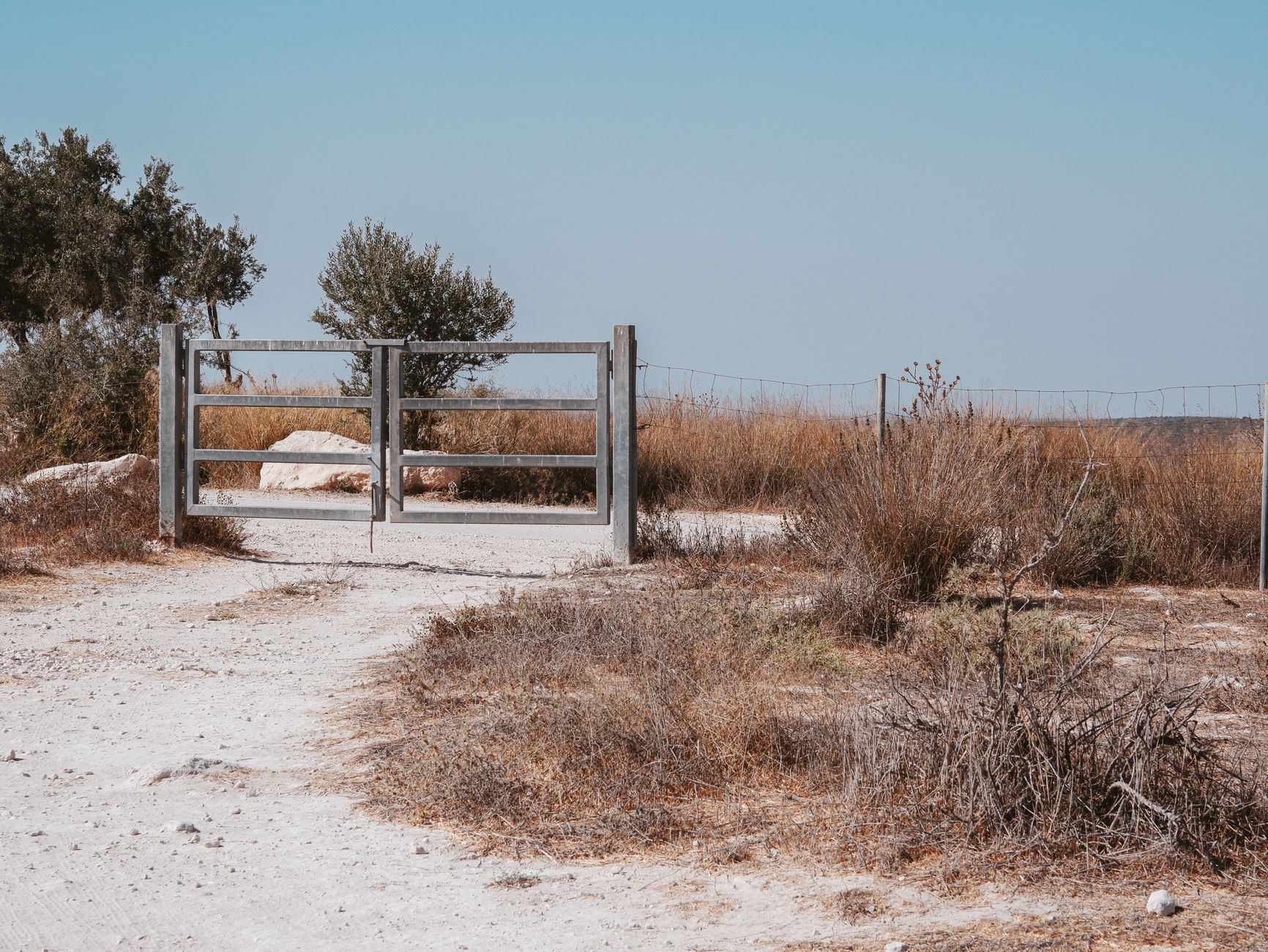 A rustic wooden gate in a countryside setting