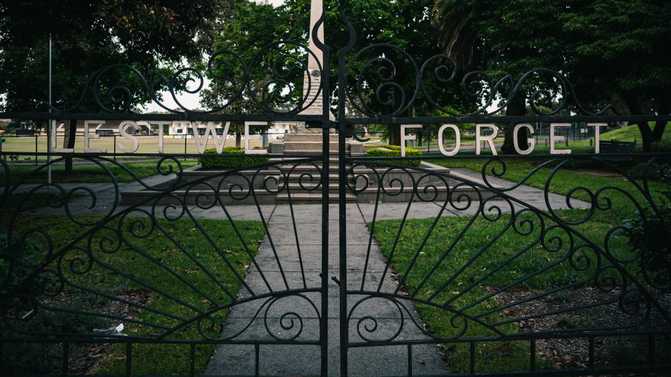 Decorative iron gate with scrollwork set between two posts