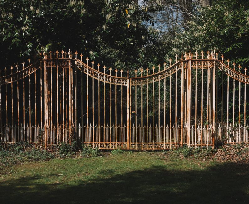 Ornate metal gate with a pattern of curved bars
